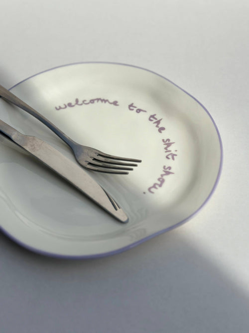 'welcome to the shit show.' Plate